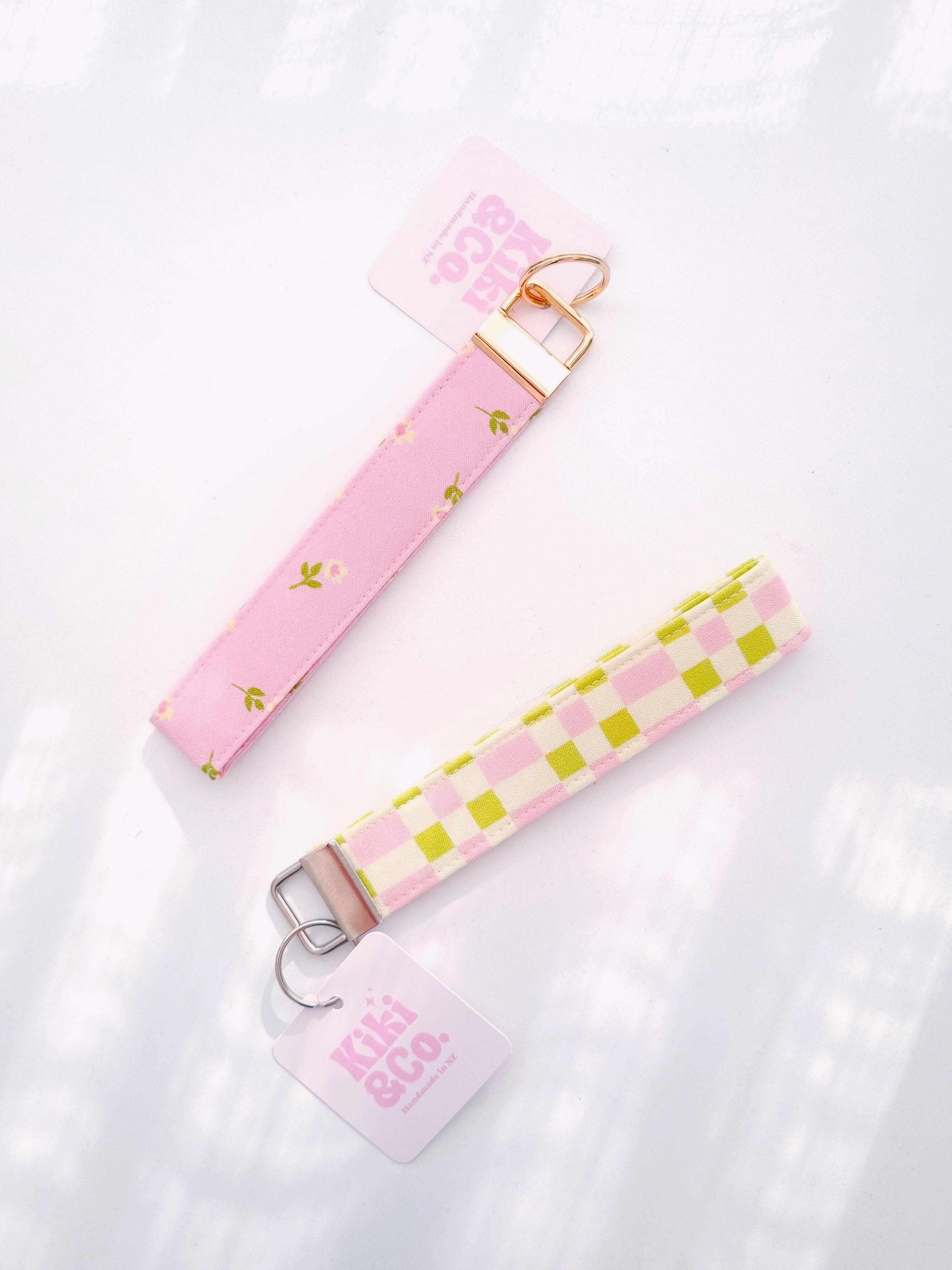 Pink petal keychain from Kiki & Co., featuring a delicate floral design on a metal key ring.