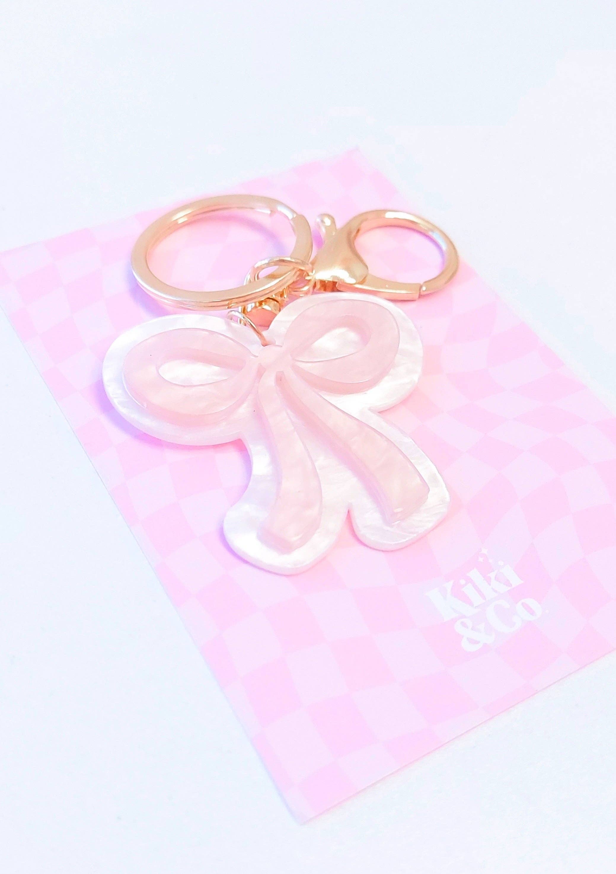 Kiki & Co. bow keyring with a pink fabric bow attached to a metal keyring for keys or accessories.