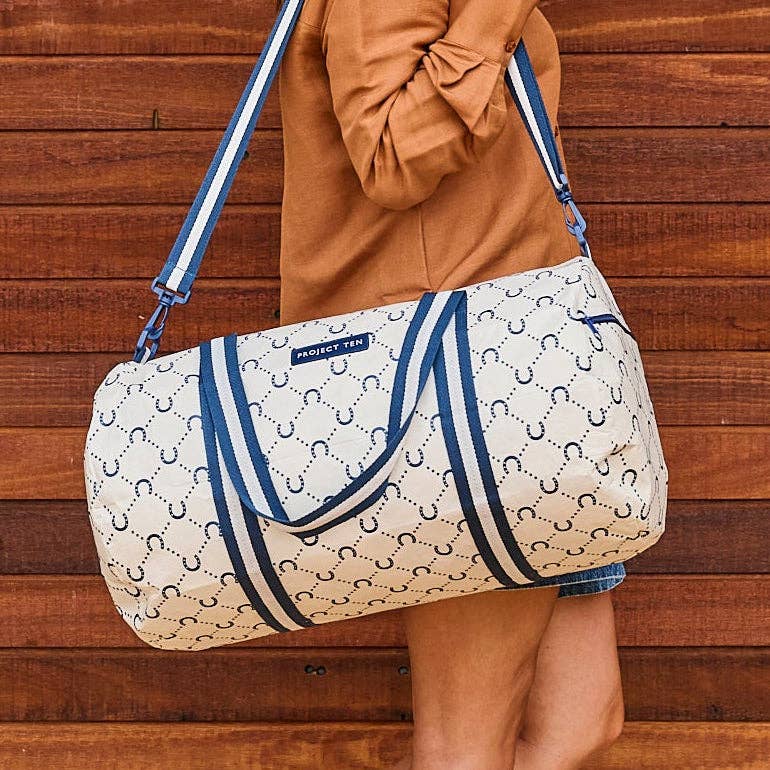 Navy barrel bag with horseshoe detail by Project Ten Pty Ltd, featuring a durable leather strap and spacious interior.