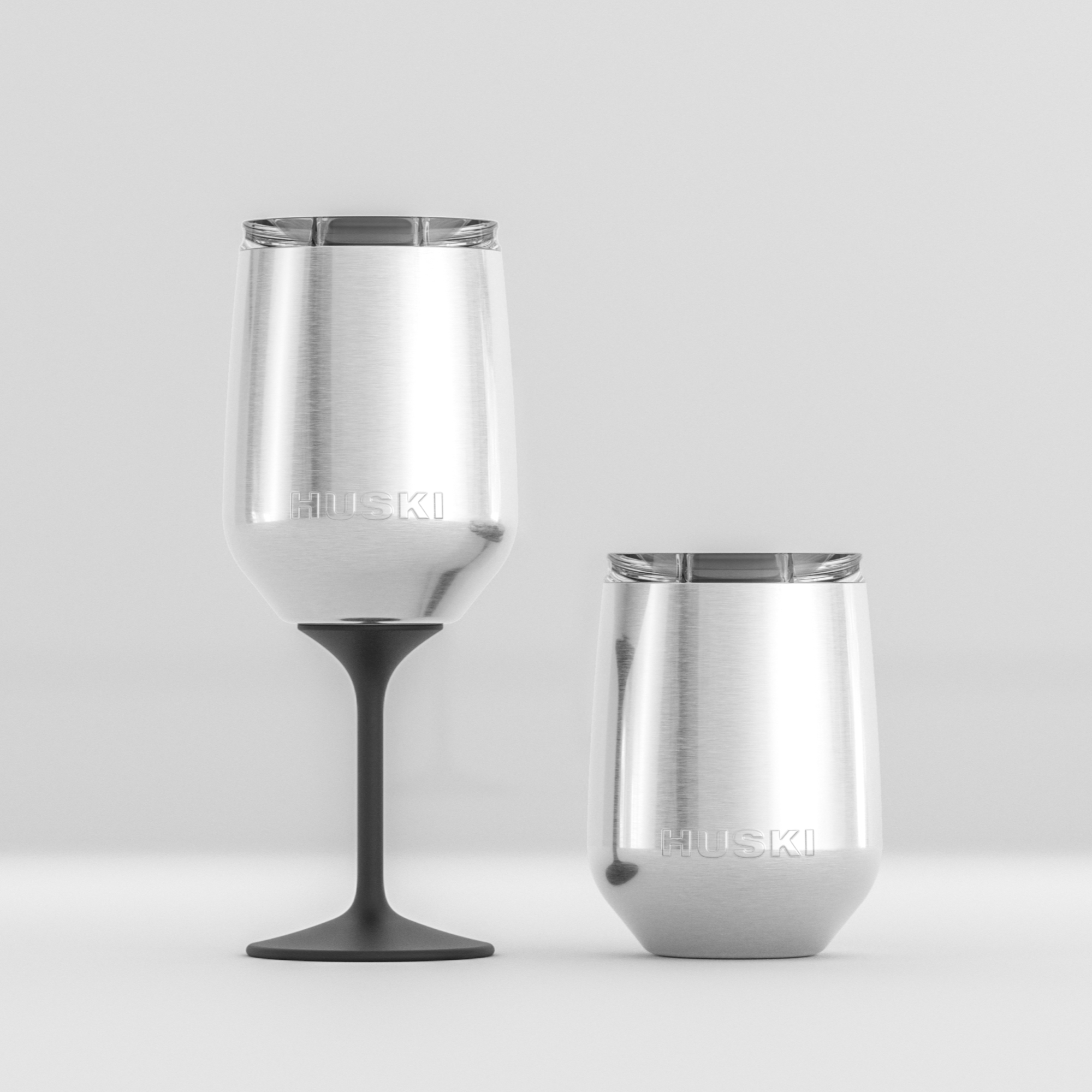 Huski Wine Tumbler 2.0 in white, insulated stainless steel wine glass with lid, designed for outdoor and travel use.