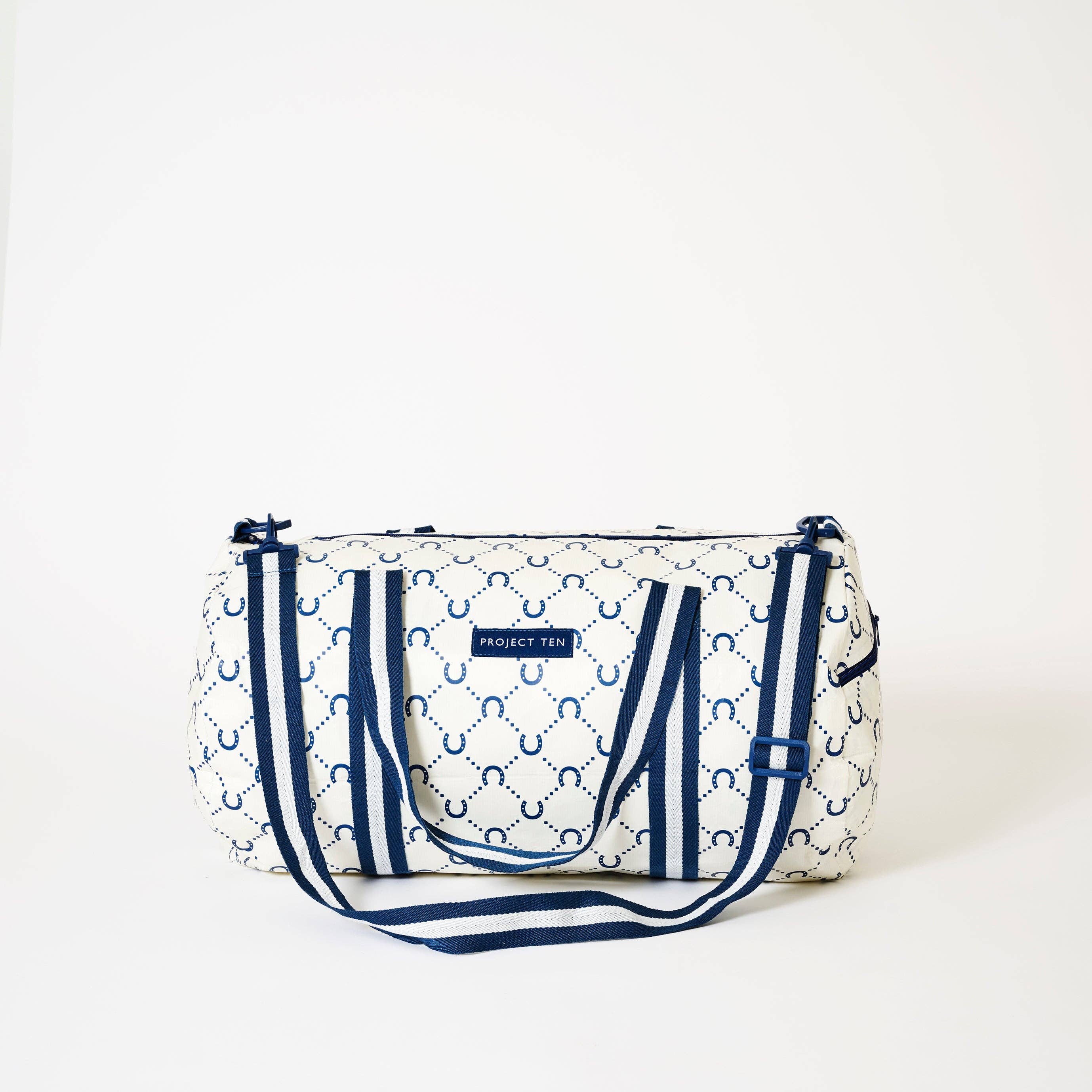Navy barrel bag with horseshoe design by Project Ten Pty Ltd, showing the textured fabric and sturdy leather straps.